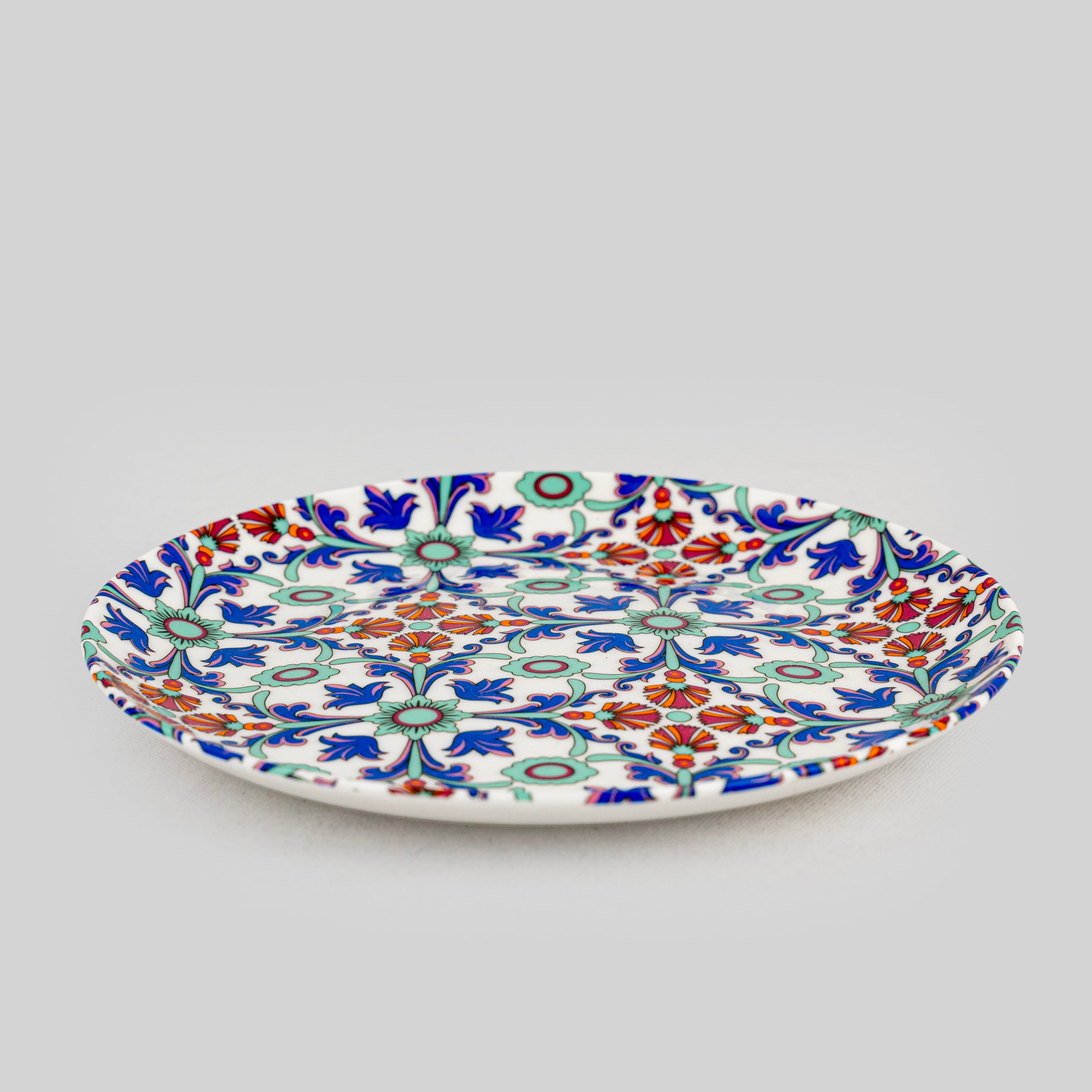 Close-up of intricate Persian floral print on porcelain
dessert plate — unusual designer tableware by tyetye india
