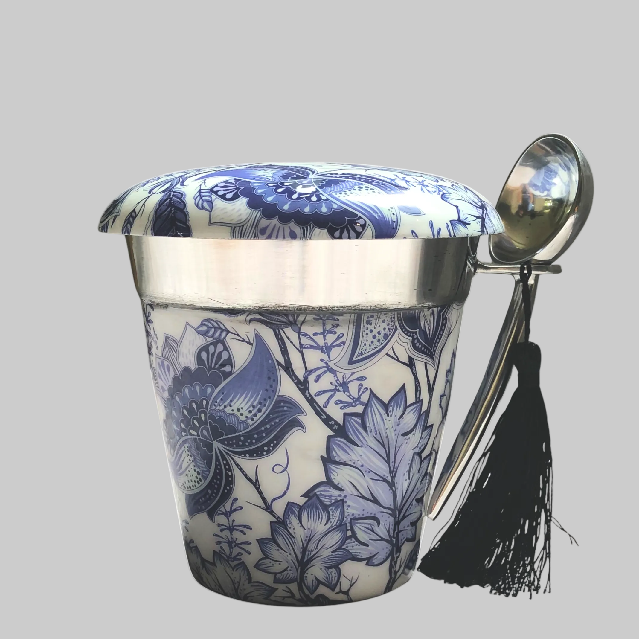 A single white porcelain footed ice cream cup with intricate blue chinoiserie patterns of florals, shown on a clean white background.
