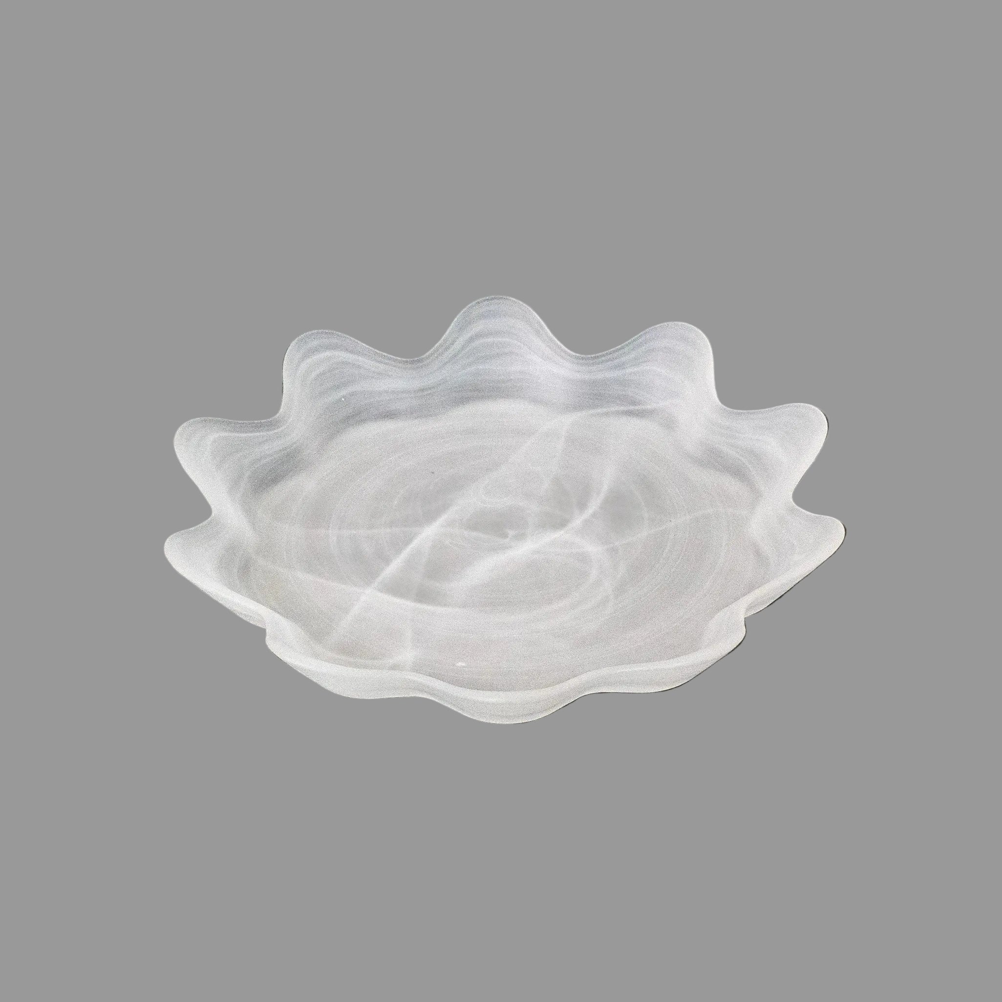 "Stylish dining setting with glass plates, enhancing the table's modern elegance."