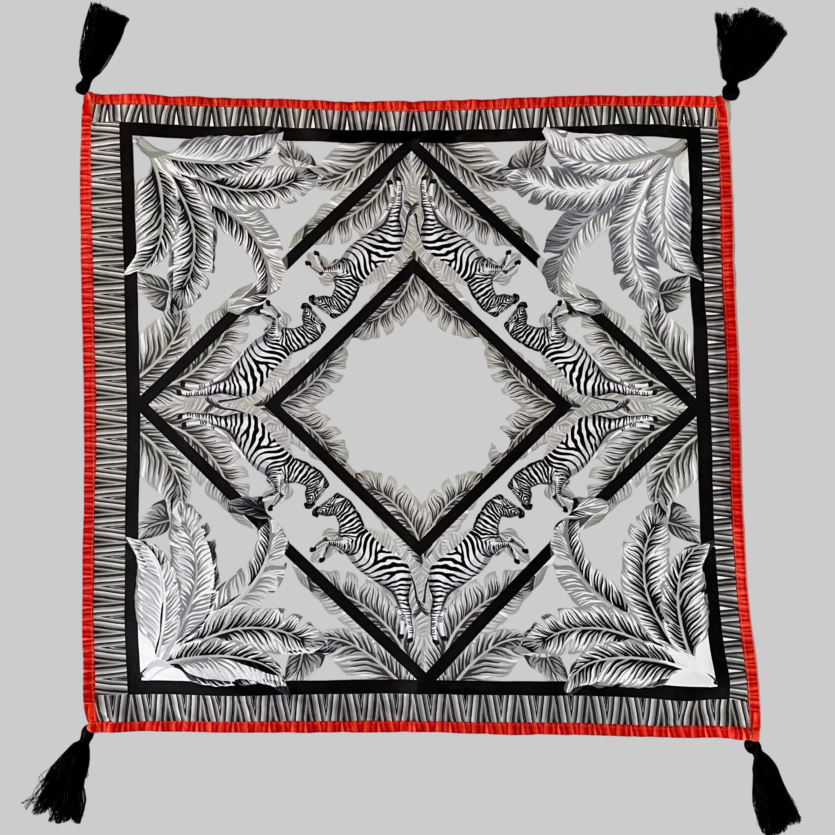 Set of four white cotton napkins with black zebra print pattern and decorative tassel