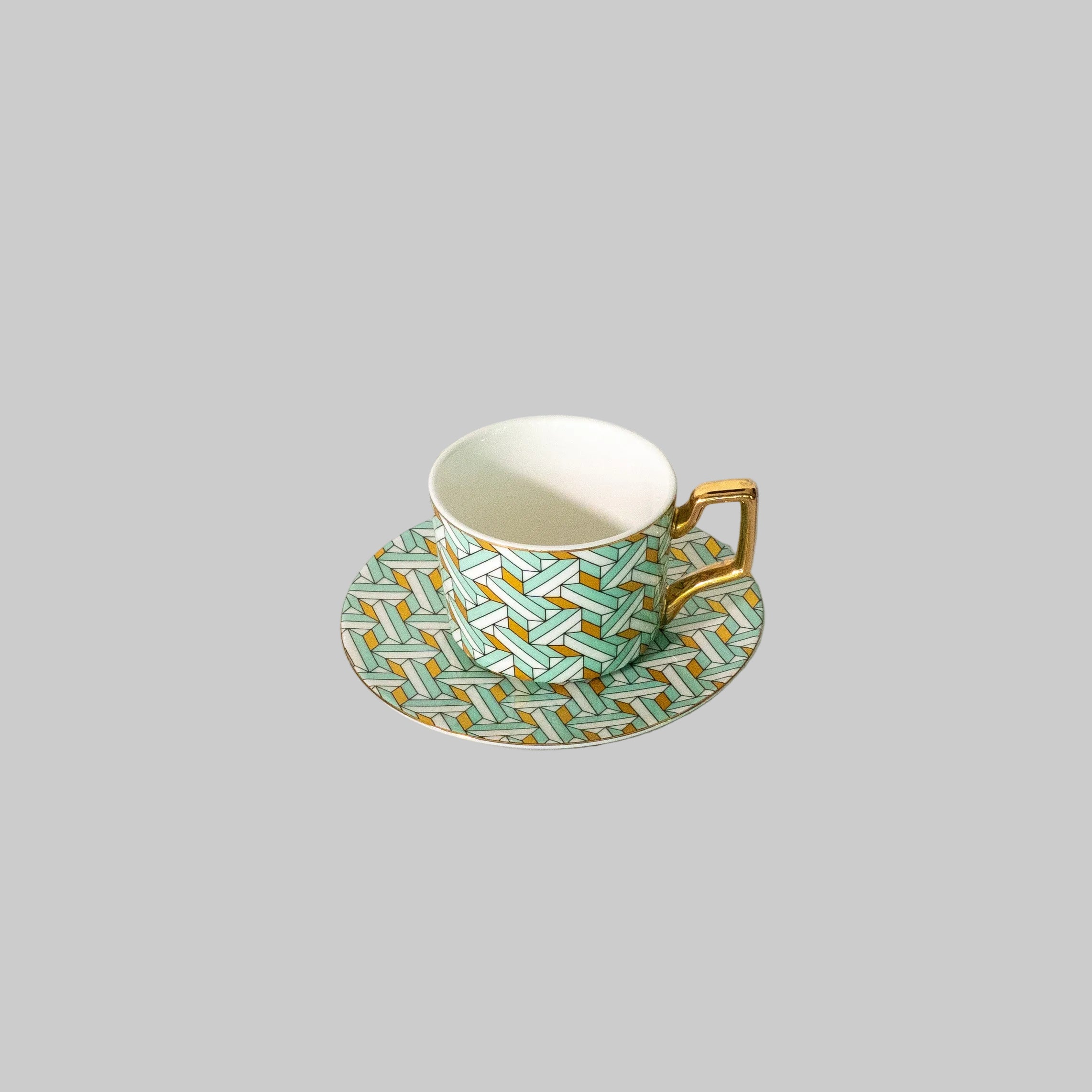 Beautifully designed mosaic teacup with intricate patterns, paired with a matching saucer."