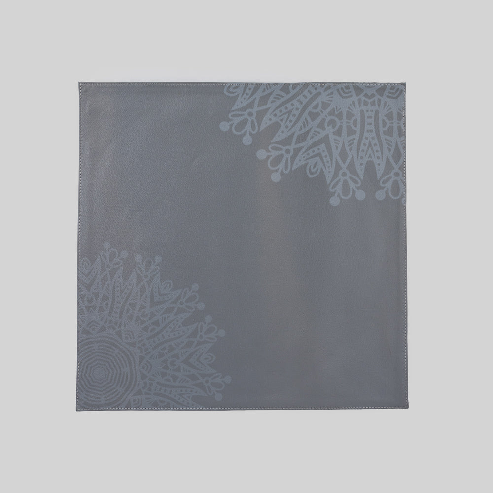 Mandala printed faux leather square tablemat enhancing a modern dining table."