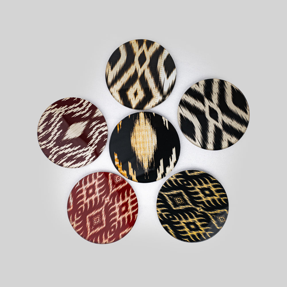 Set of ikat weave coasters arranged on a wooden table, adding a boho touch to decor.