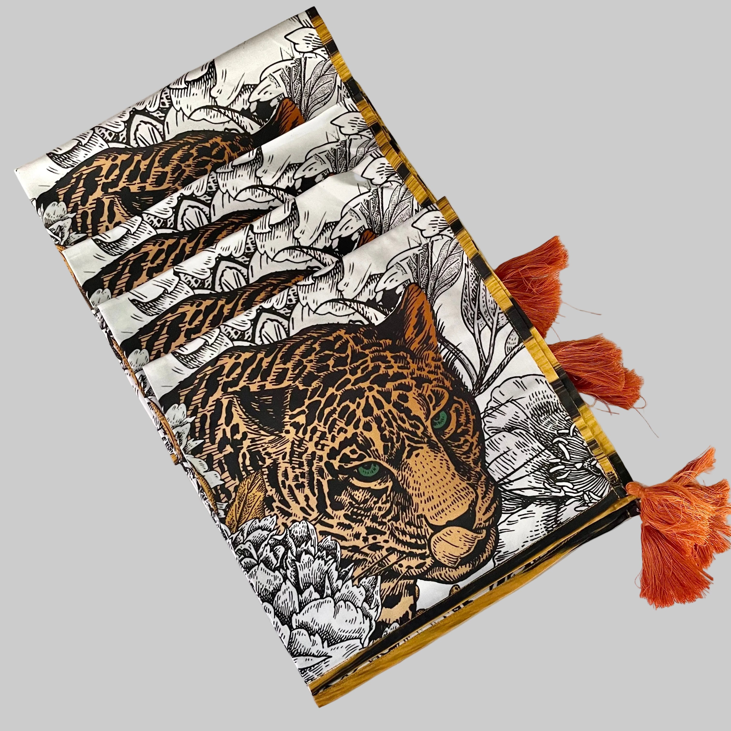 Set of four white cotton napkins with brown leopard print pattern and decorative tassel trim, 17 inch square dinner napkins