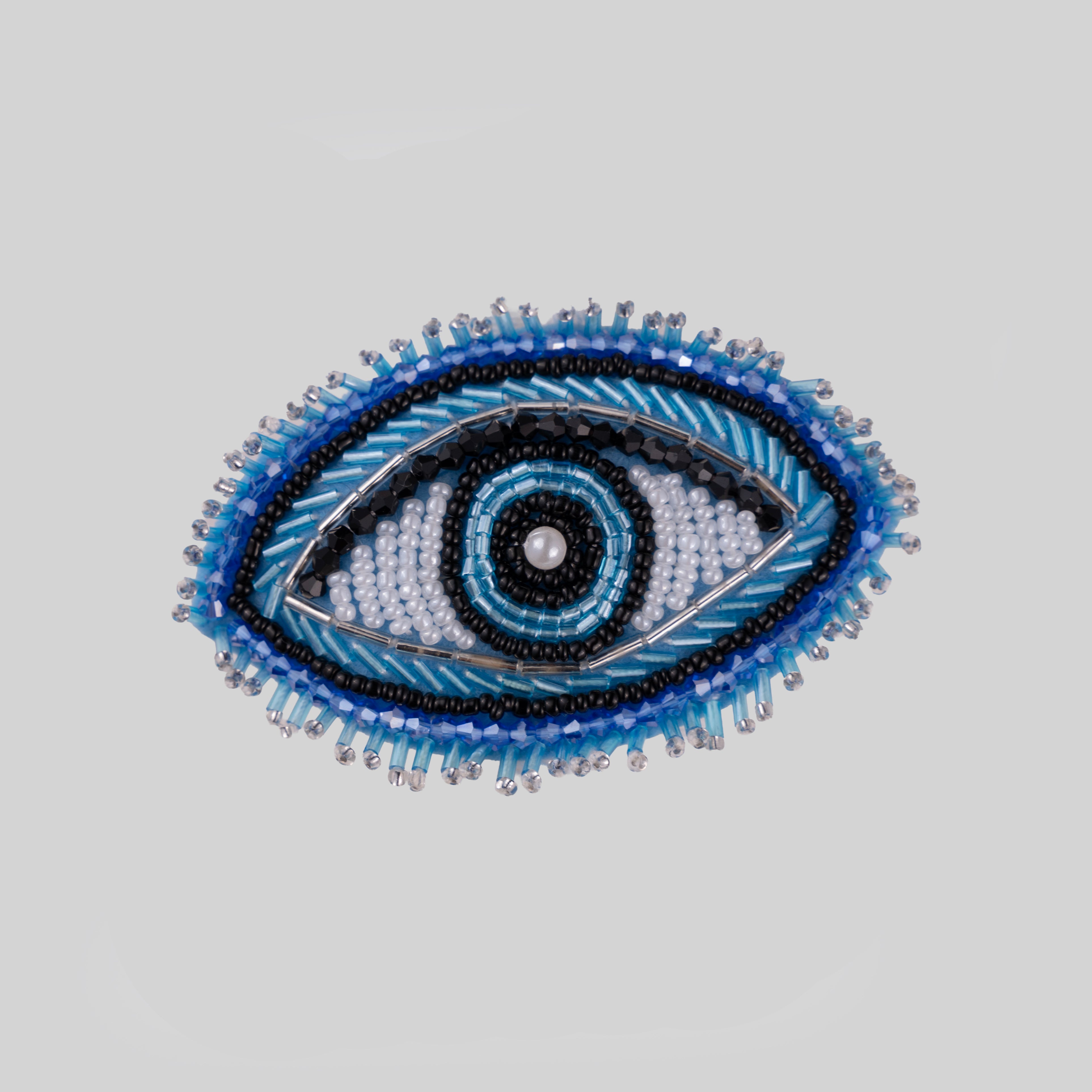 Handbeaded evil eye napkin ring on clear acrylic band in blue, black and white seed beads with crystal detailing — tyetye India luxury tableware