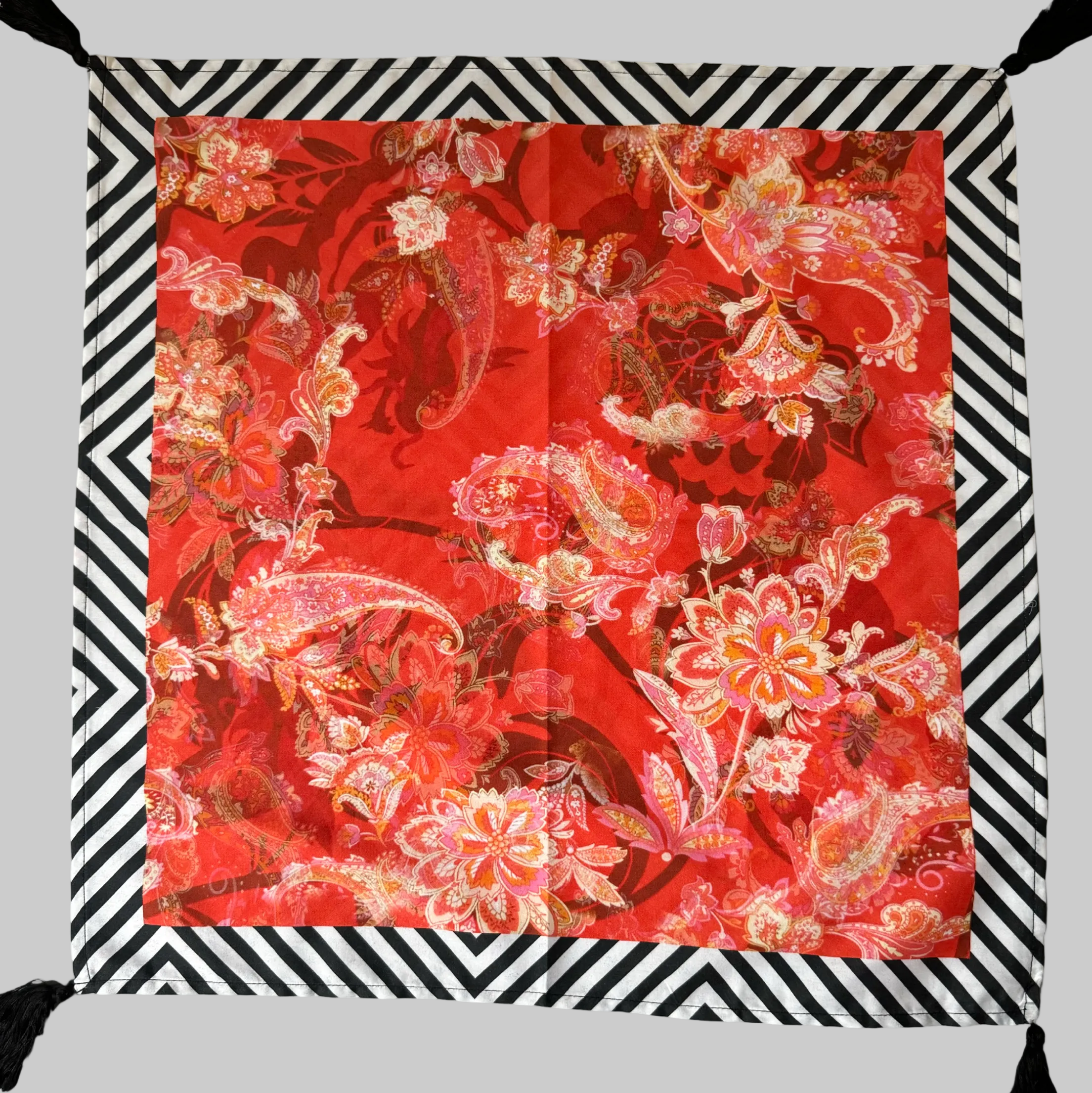 set of vibrant red cotton napkins with bold dragon motifs, displayed on a dining table.